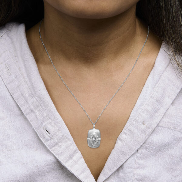 Medallion pendant necklace worn at the neckline showing chain drop and pendant placement