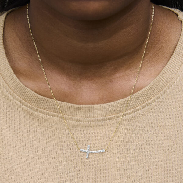 Cross bar necklace worn on a model, showing the pendant resting on the chain at length
