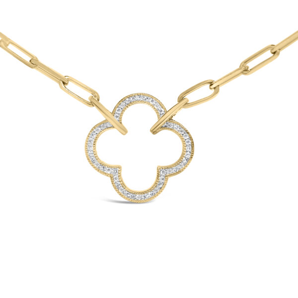 Close-up of the clover pendant showing pavé-set round diamonds along its outline
