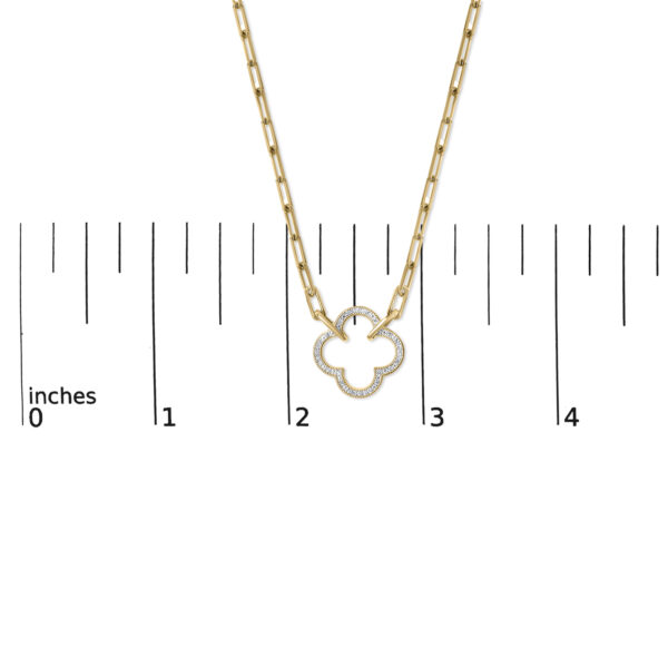 Clover pendant necklace shown next to a ruler indicating its size in inches