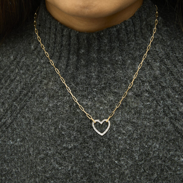 Necklace worn on a model, pendant hanging at the front of the neck