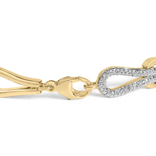 Close-up of the bracelet's knot links showing pave-set round diamonds catching light