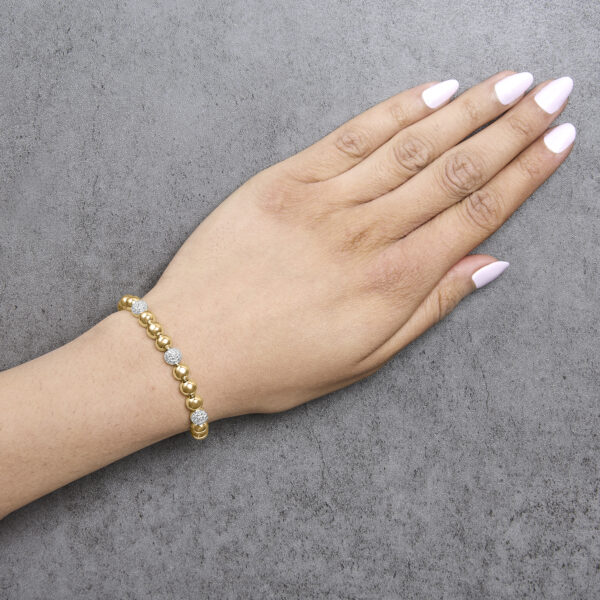 24K Gold plated dome bead link bracelet worn on a wrist