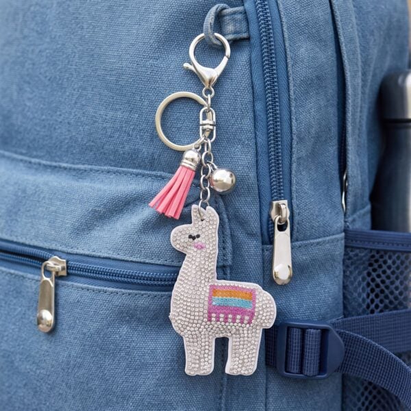 Alternate view of a silver plated llama bag charm with crystal details.