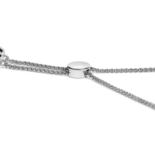 Close view of prong-set round diamonds along the infinity heart links of a bolo bracelet